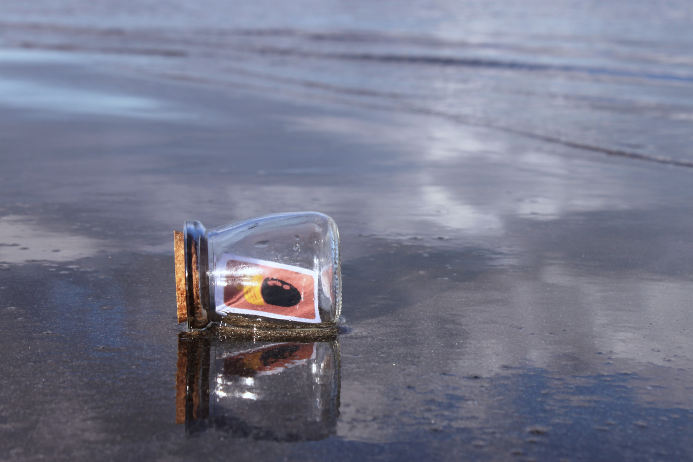 An animal crossing new horizons DIY jar laying on wet sand